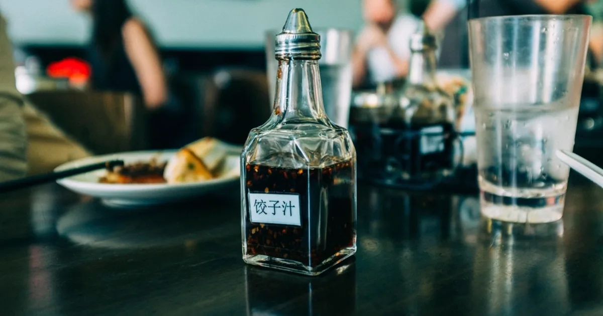 A bottle of soy sauce on a table, a staple of the Japanese pantry